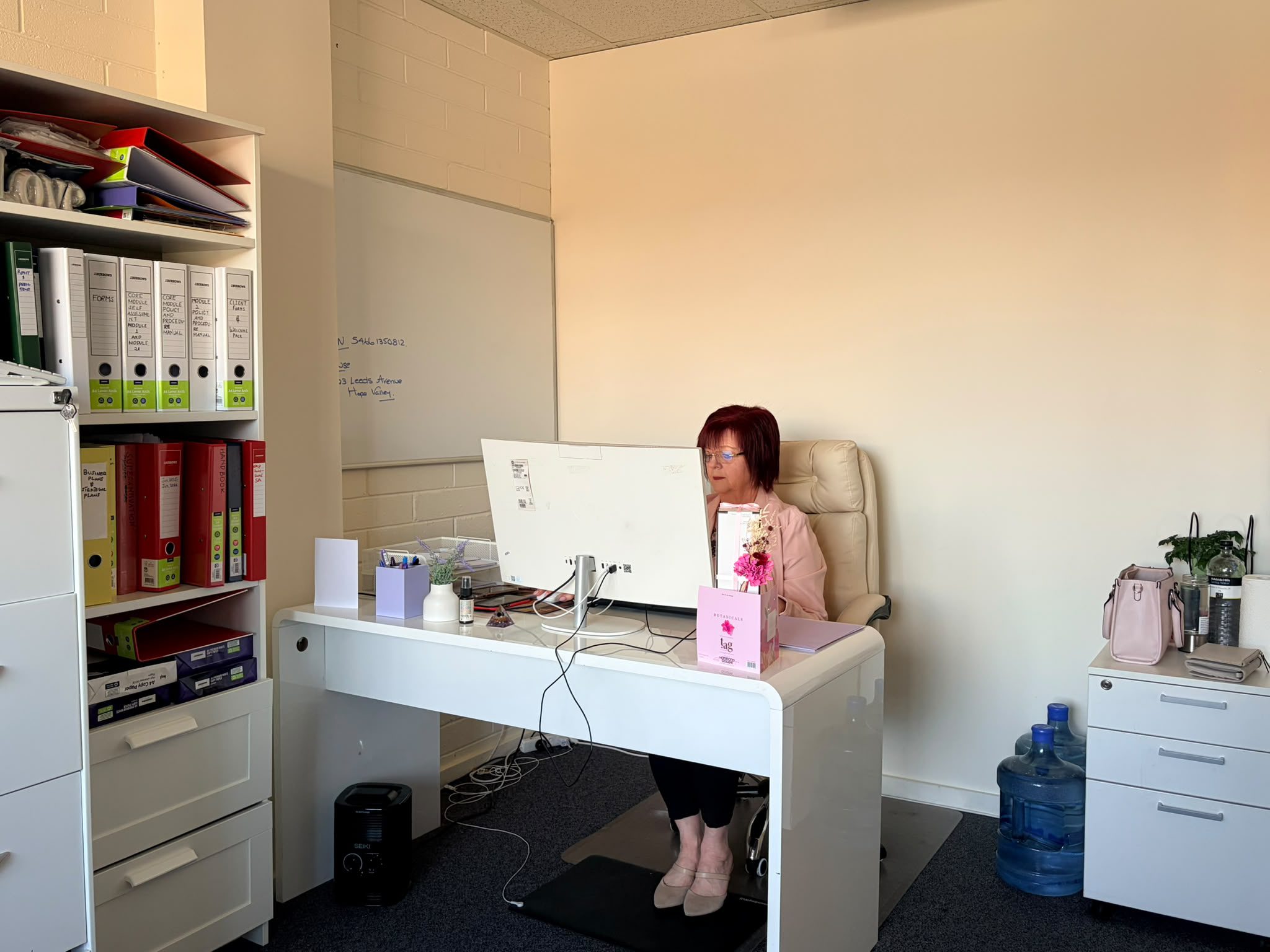 Destiny Community Services team member working at office desk